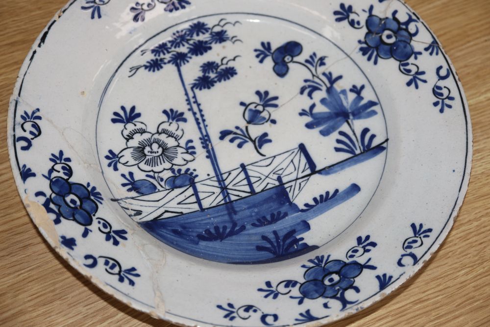 Four 18th century Delft blue and white dishes, largest 35cm (a.f.)